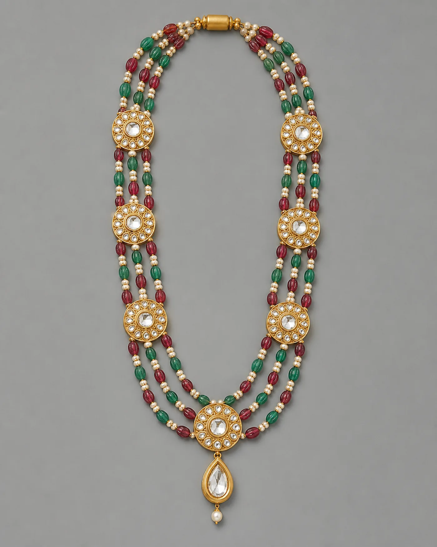 Three-strand rani haar of kundan-set polki roundels strung with carved ruby and emerald beads and pearls