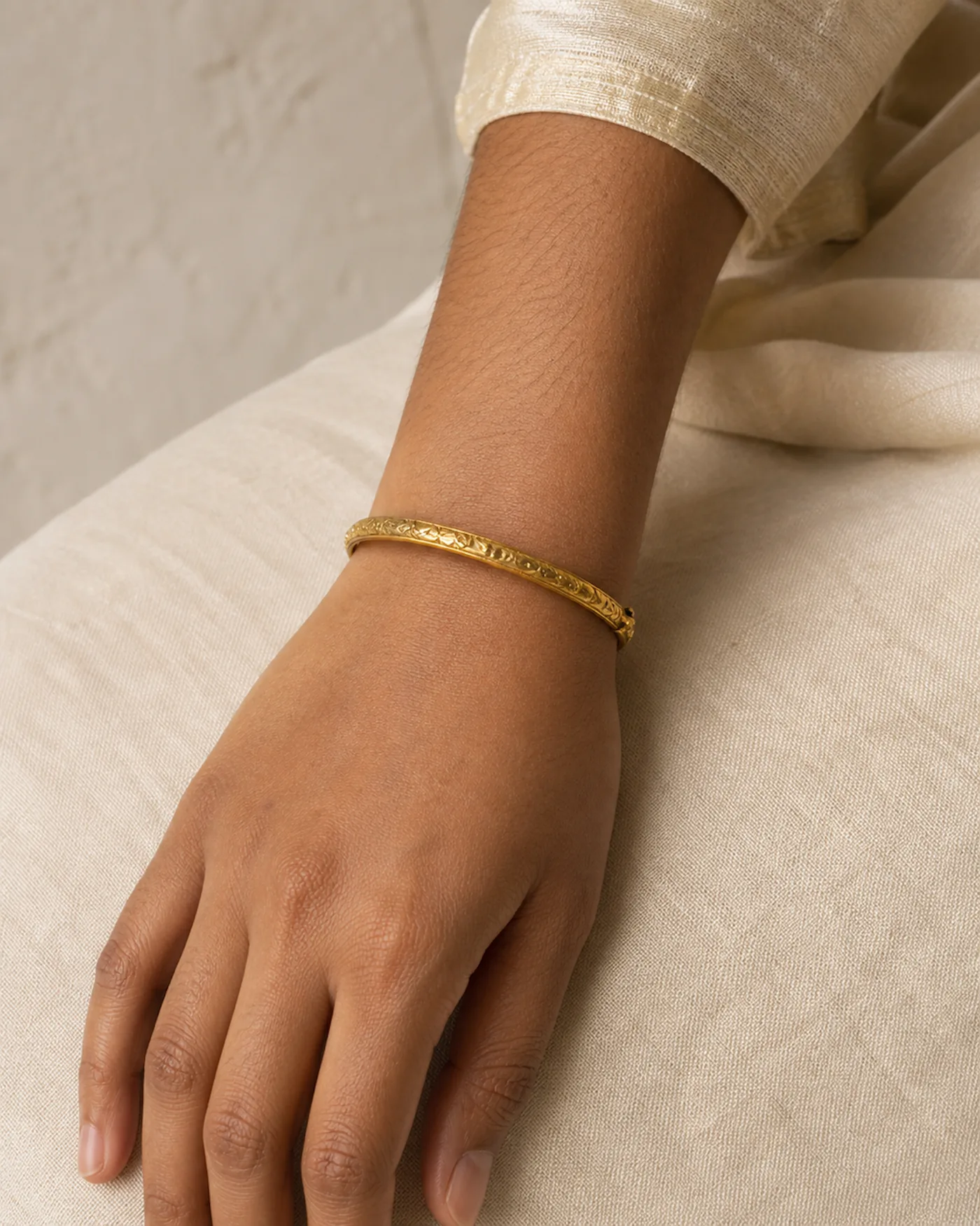 The kada worn on a wrist, showing how slim the chased band sits